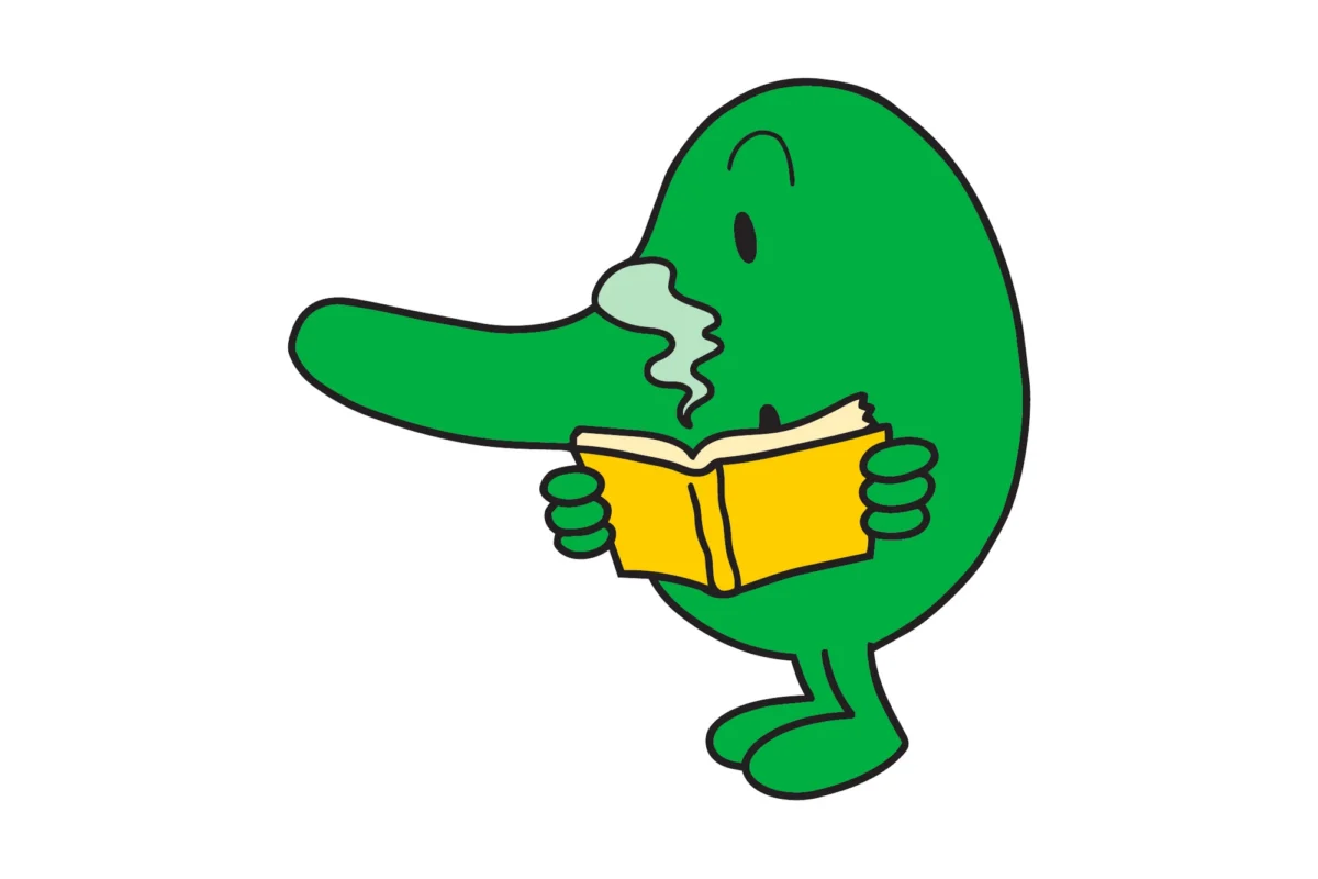Un Monsieur vert au long nez lit un livre en reniflant une odeur